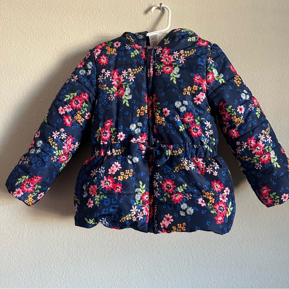 Little Me floral puffer jacket with a fleece lining and a bow detail  waist.